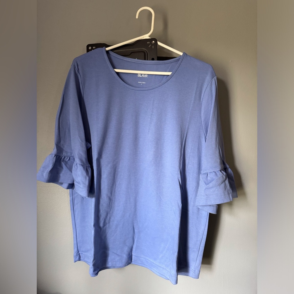 Women’s size large, light blue top with ruffle on three-quarter sleeve